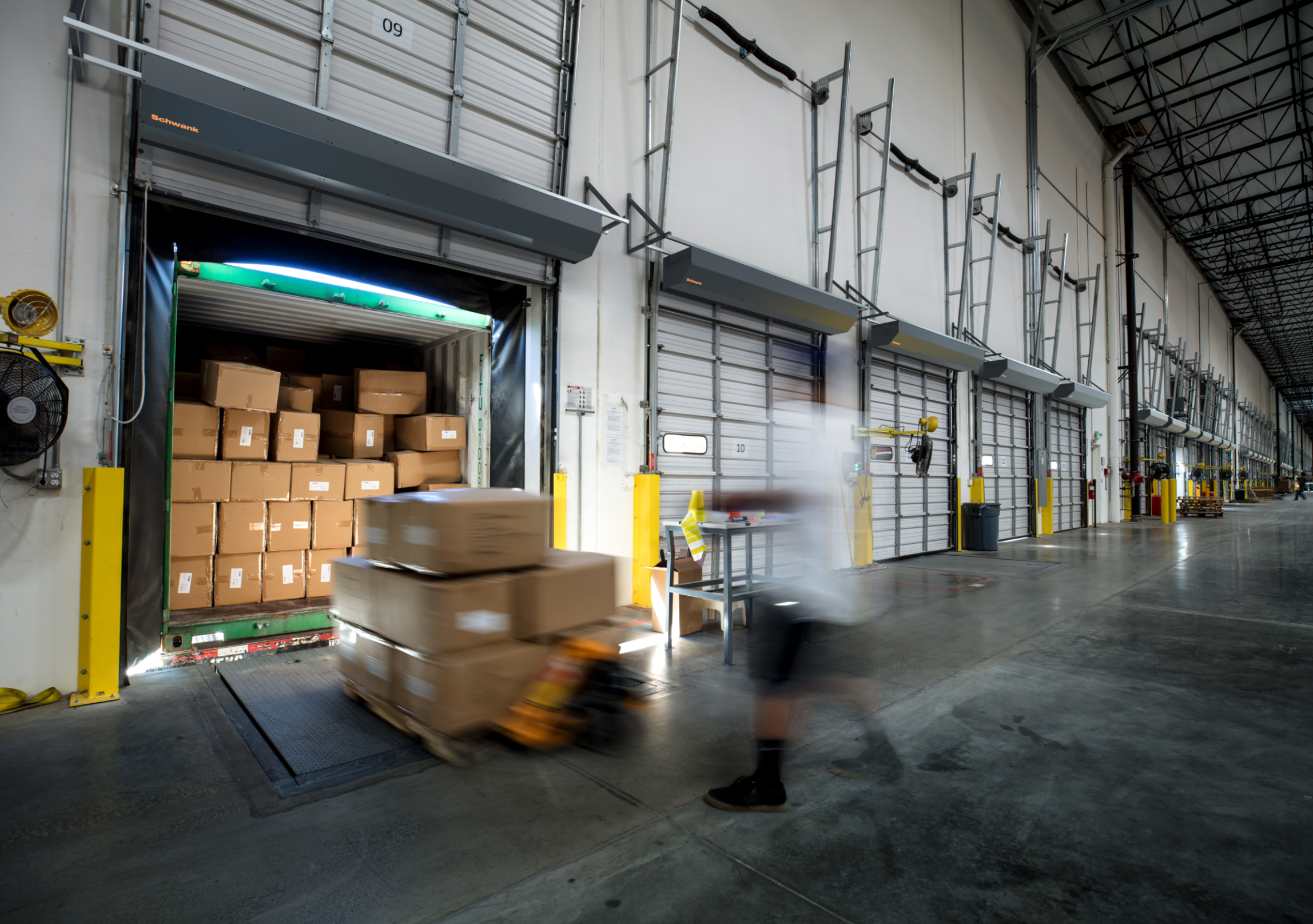 Schwank Epic12 36 inch ambient industrial air curtain wall mounted above warehouse entrance doorway